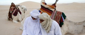 Beduins using a laptop in the Sahara